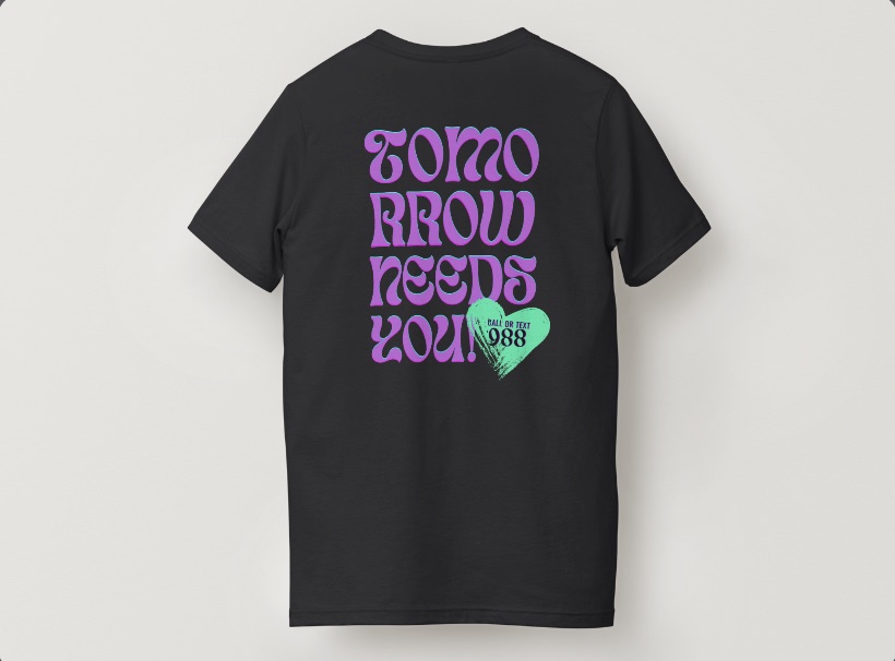 The Empathy Equation team shirt, back view: &ldquo;Tomorrow needs you!&rdquo; in purple over a green heart reading call or text 988.